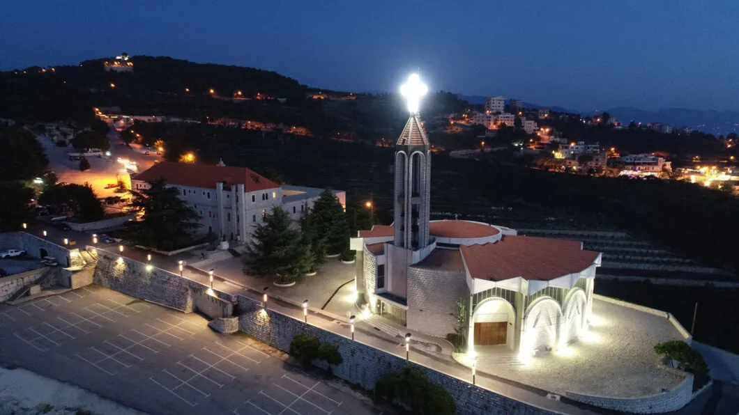 Aerial view of Saint Charbel's church and the monastery of Saint Maron at Annaya, lit up at dusk